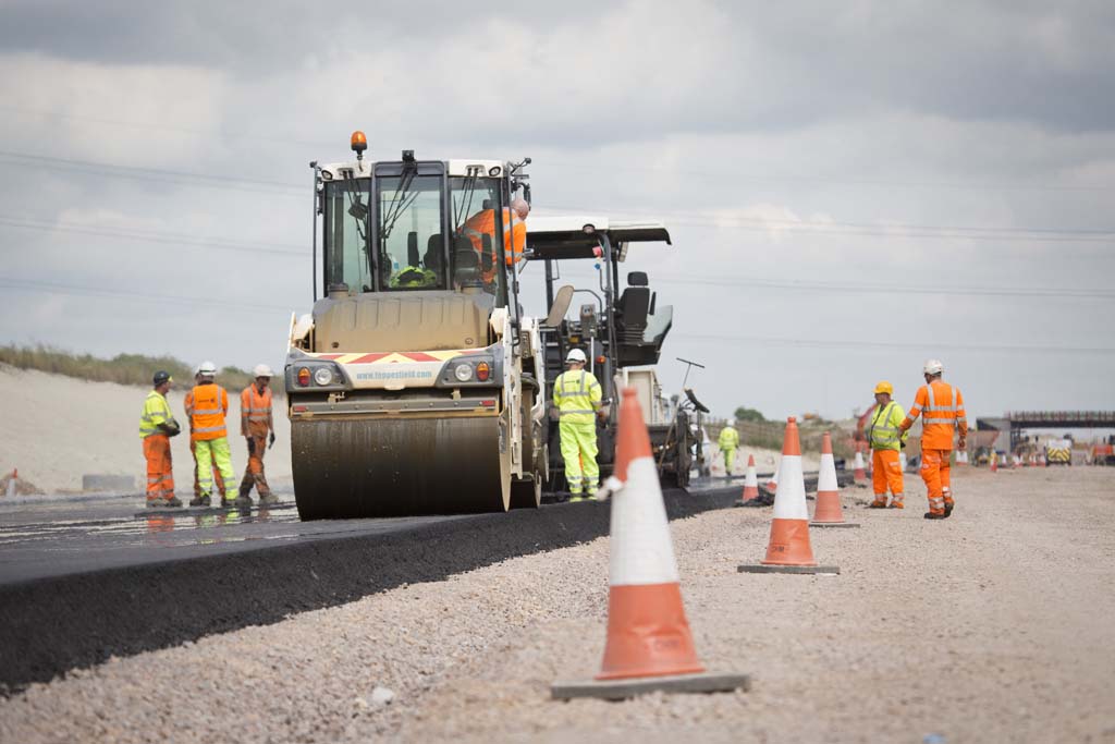 Roadwork construction with roller and orange cones