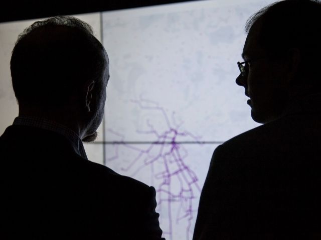Researchers look at map of transport network