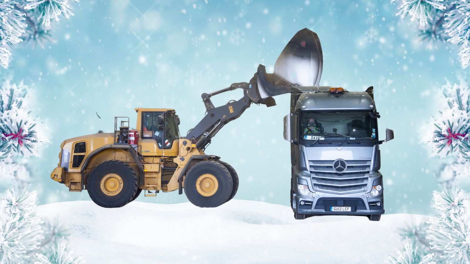 Digger and truck in festive snow scene