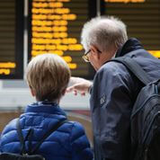 couple look at destination board