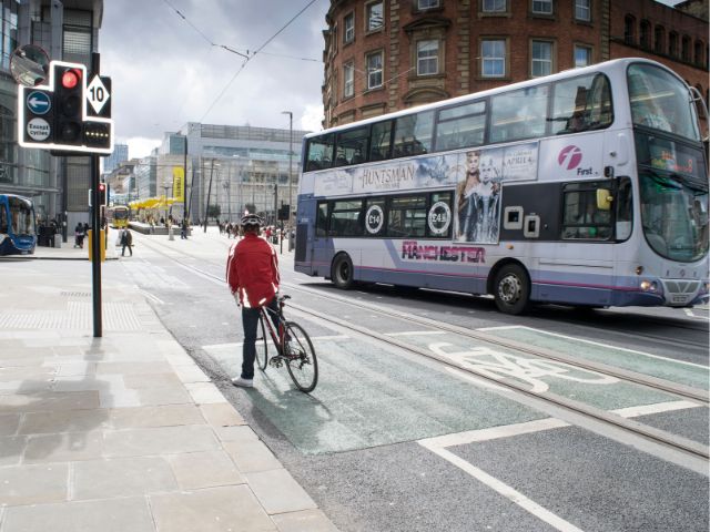 Bus and cyclist in Manchester city centre
